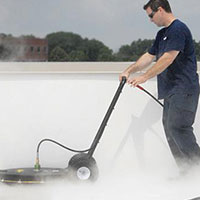 worker cleaning a roof