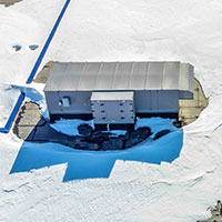 snow around HVAC unit on top of roof