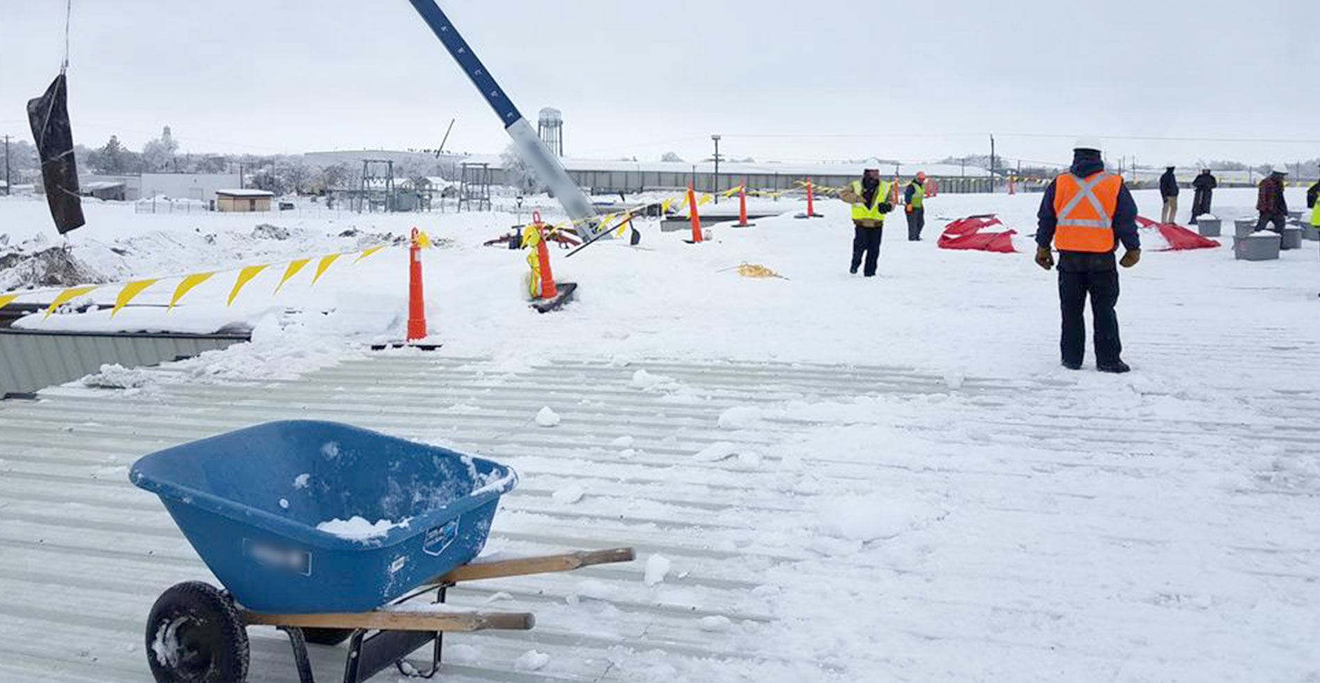 roofers removing snow from a commercial roof