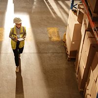 a woman walking through a warehouse